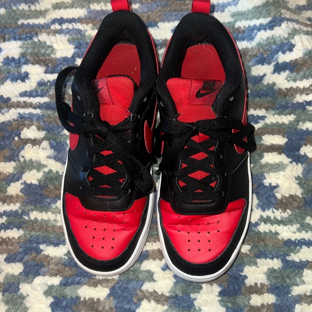 Red and black Nike all day play